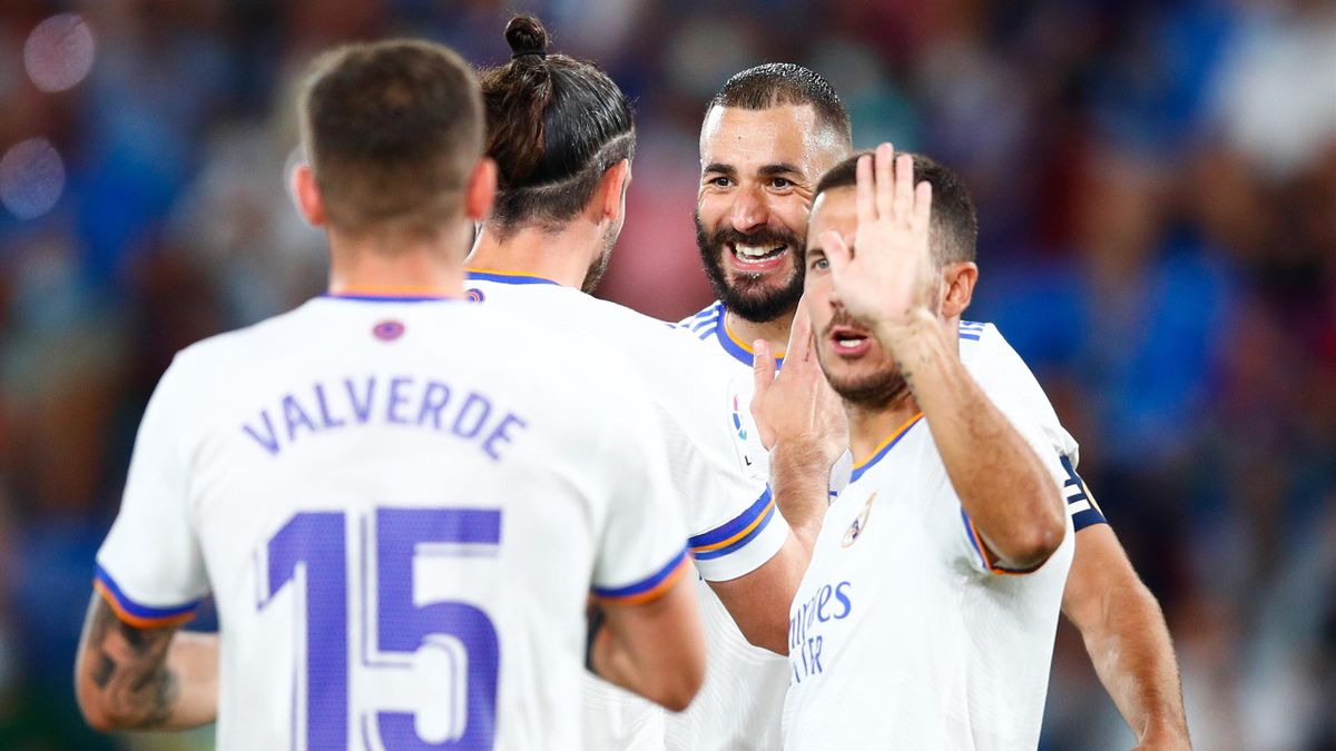 Gareth Bale of Real Madrid celebrates scoring his side's first goal with Karim Benzema and Eden Hazard of Real Madrid during the La Liga Santader match between Levante UD and Real Madrid CF at Ciutat de Valencia Stadium on August 22, 2021 in Valencia
