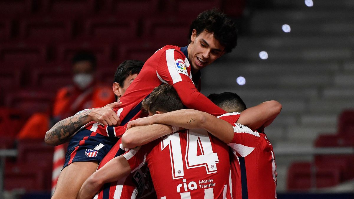 Atletico Madrid's Portuguese midfielder Joao Felix (top) jumps on teammates as they celebrate their second goal during the Spanish League football match between Atletico de Madrid and Athletic Bilbao at the Wanda Metropolitano stadium in Madrid on March 1