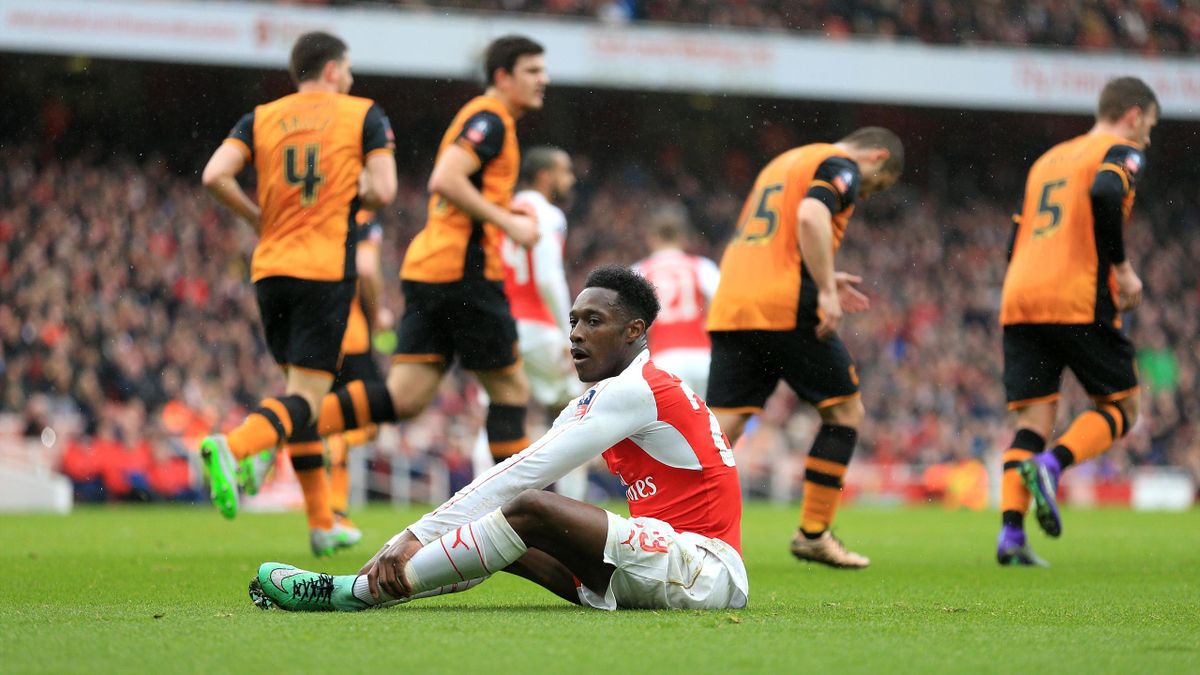 Arsenal's Danny Welbeck sits dejected after missing a chance.