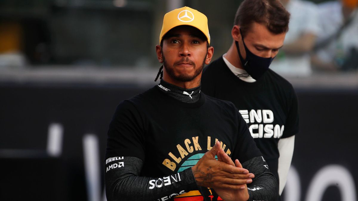 Mercedes' British driver Lewis Hamilton (C) takes part in the End Racism event ahead of the Abu Dhabi Formula One Grand Prix at the Yas Marina Circuit in the Emirati city of Abu Dhabi on December 13, 2020
