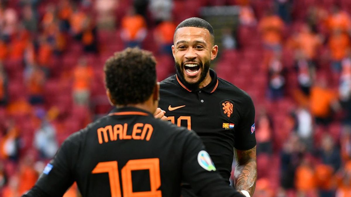 Memphis Depay of Netherlands celebrates with teammate Donyell Malen after scoring their side's first goal during the UEFA Euro 2020 Championship Group C match between North Macedonia and The Netherlands at Johan Cruijff Arena on June 21, 2021 in Amsterdam