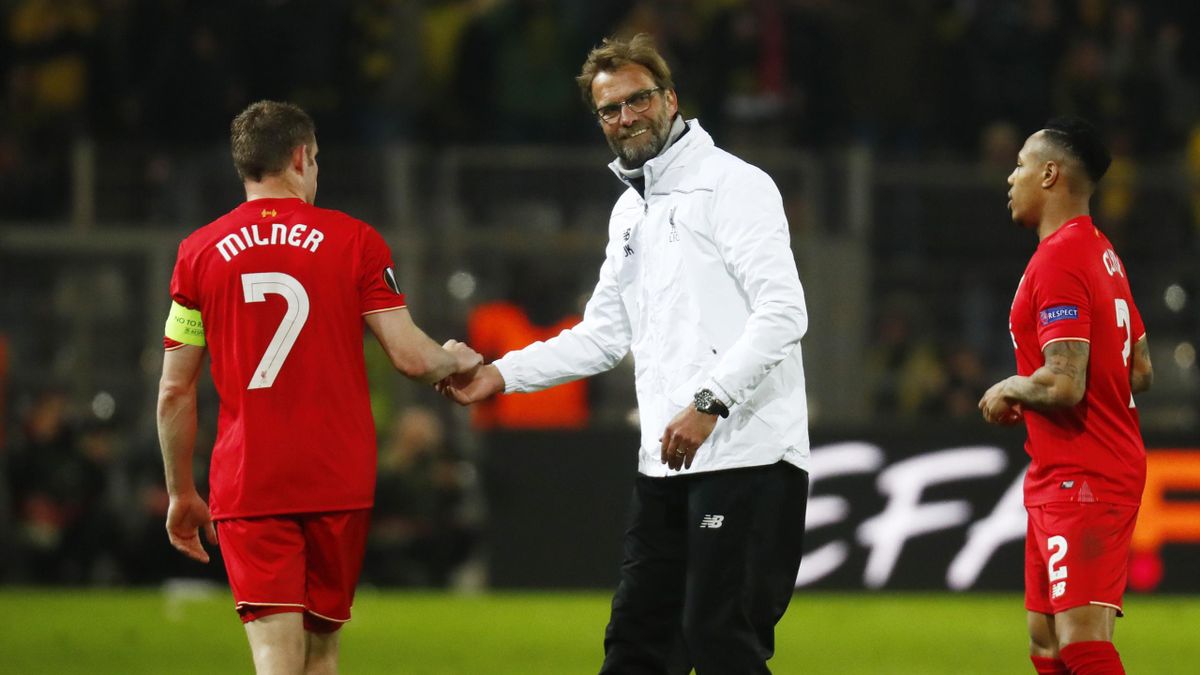 Liverpool manager Juergen Klopp shakes hands with James Milner after the game as Nathaniel Clyne looks on