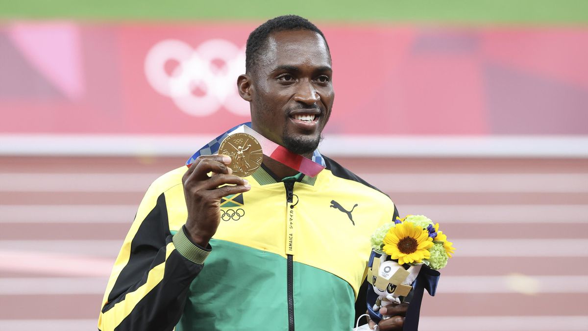 TOKYO, JAPAN - AUGUST 5: Gold Medalist Hansle Parchment of Jamaica during the medal ceremony of the Men's 110m Hurdles Final on day thirteen of the athletics events of the Tokyo 2020 Olympic Games at Olympic Stadium on August 5, 2021 in Tokyo, Japan. (Pho