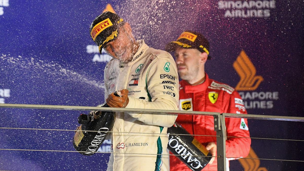 Race winner Lewis Hamilton of Great Britain and Mercedes GP celebrates on the podium