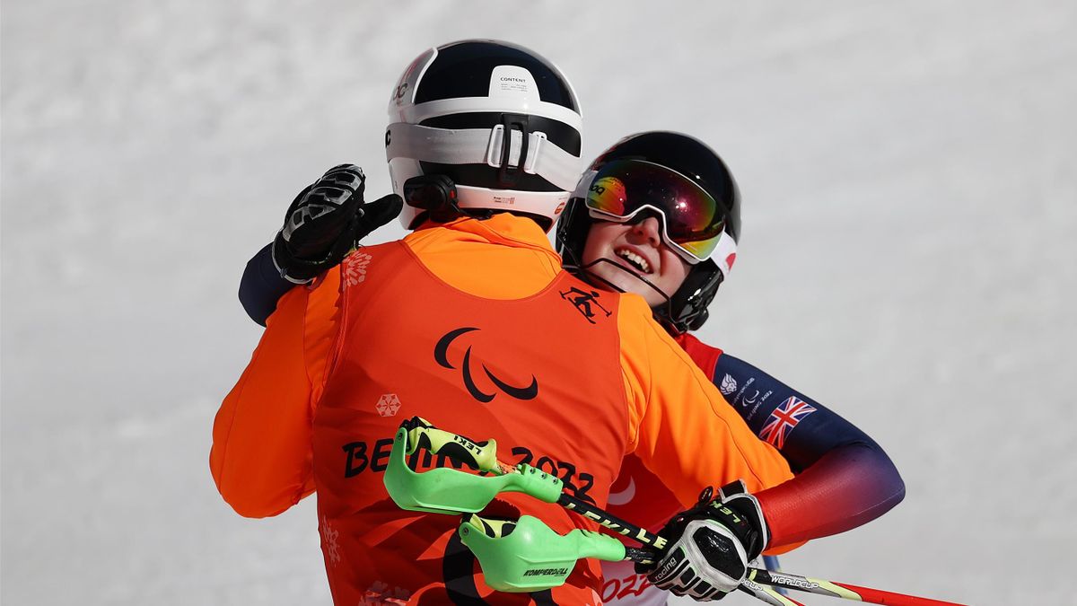 Menna Fitzpatrick of Team Great Britain hugs her guide following the Para Alpine Skiing Women's Super Combined Slalom Vision Impaired at Yanqing National Alpine Skiing Centre