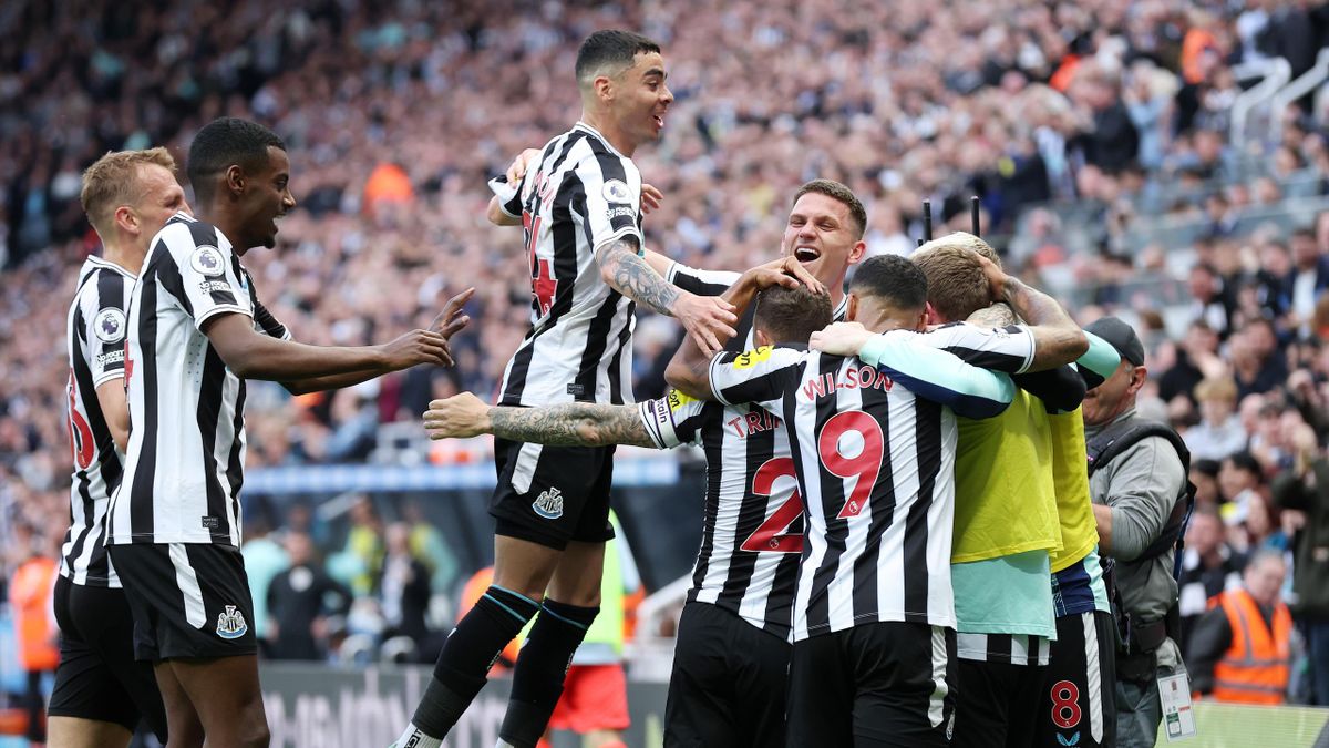 Players of Newcastle United celebrate their side's first goal, an own goal by Deniz Undav of Brighton & Hove Albion (not pictured), during the Premier League match between Newcastle United and Brighton & Hove Albion at St. James' Park