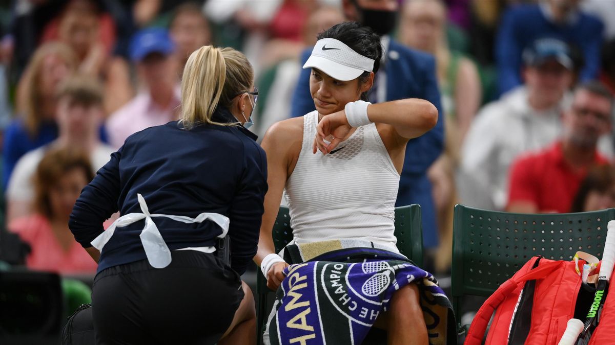 Emma Raducanu of Great Britain receives medical treatment in her Ladies' Singles Fourth Round match against Ajla Tomljanovic of Australia during Day Seven of The Championships - Wimbledon 2021