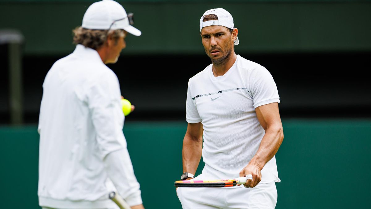 Rafael Nadal of Spain practices on centre court at the AELTC with coaches Francisco Roig and Marc Lopez in a historic first time ever use of centre court for a singles player practice session before the start of The Championships Wimbledon 2022.