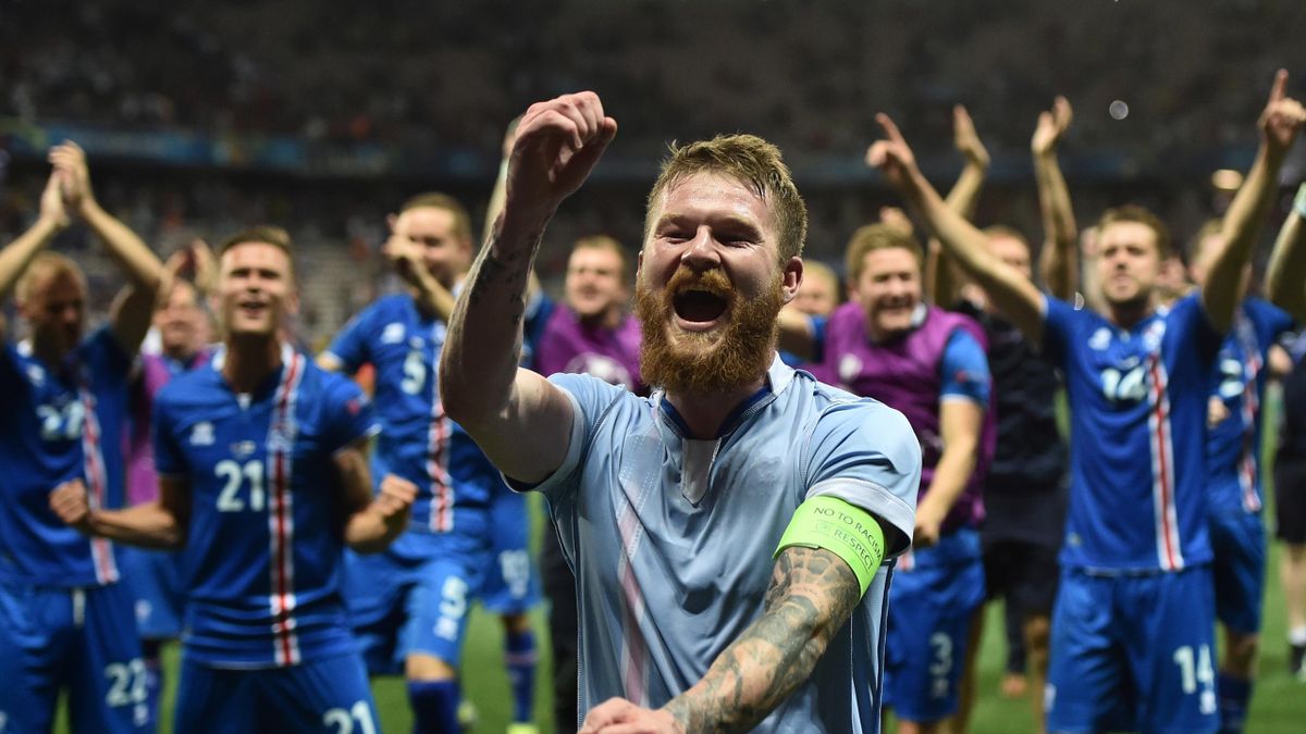 Iceland's midfielder Aron Gunnarsson and team mates celebrate after the Euro 2016 round of 16 football match between England and Iceland at the Allianz Riviera stadium in Nice on June 27, 2016. Iceland won the match 1-2.
