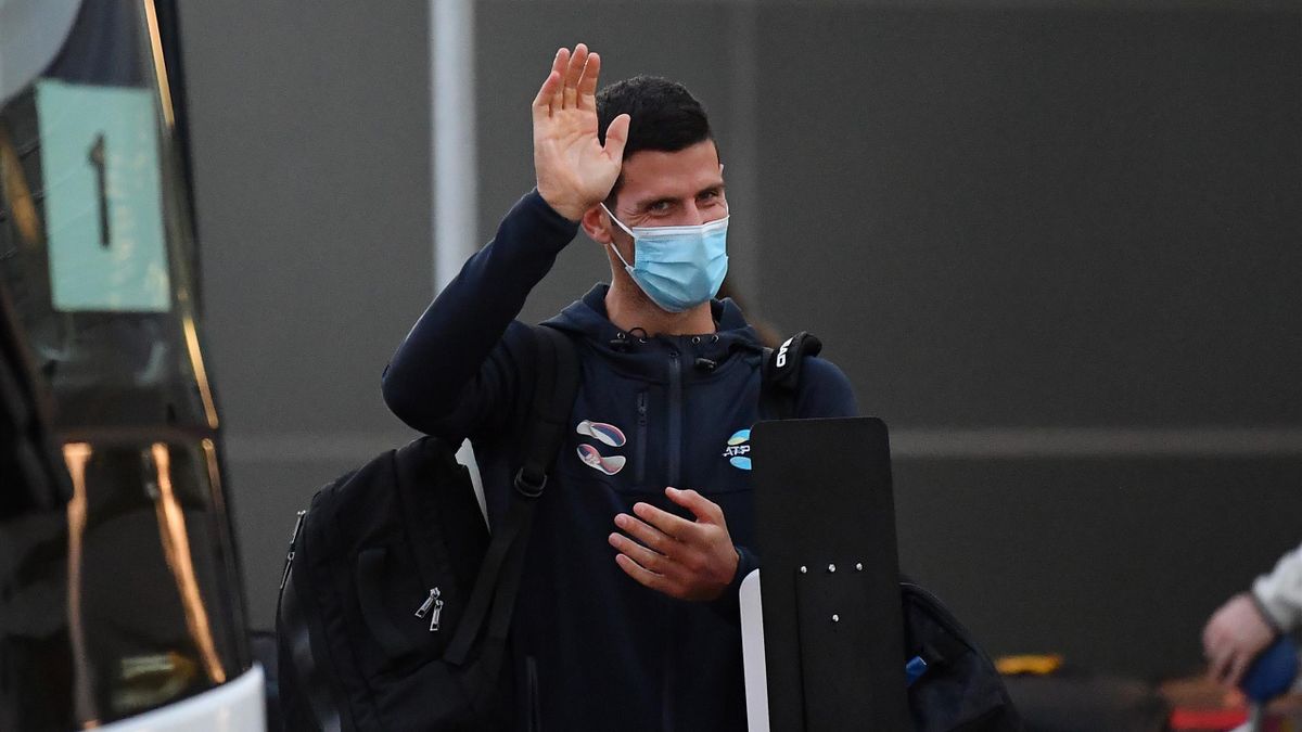 Novak Djokovic waves as he arrives at Adelaide Airport