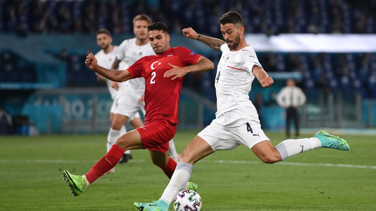 Leonardo Spinazzola of Italy shoots whilst under pressure from Zeki Celik of Turkey during the UEFA Euro 2020 Championship Group A match between Turkey and Italy at the Stadio Olimpico on June 11, 2021 in Rome, Italy