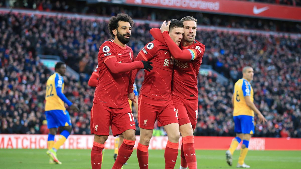 LIVERPOOL, ENGLAND - NOVEMBER 27: Mohamed Salah of Liverpool (L) and Jordan Henderson of Liverpool (R) celebrate with Andrew Robertson of Liverpool after his assist helped set up their 1st goal during the Premier League match between Liverpool and Southam