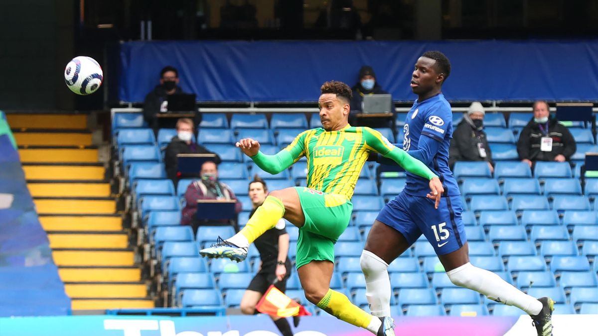West Bromwich Albion's Brazilian midfielder Matheus Pereira (L) scores his team's opening goal during the English Premier League football match between Chelsea and West Bromwich Albion at Stamford Bridge in London on April 3, 2021.