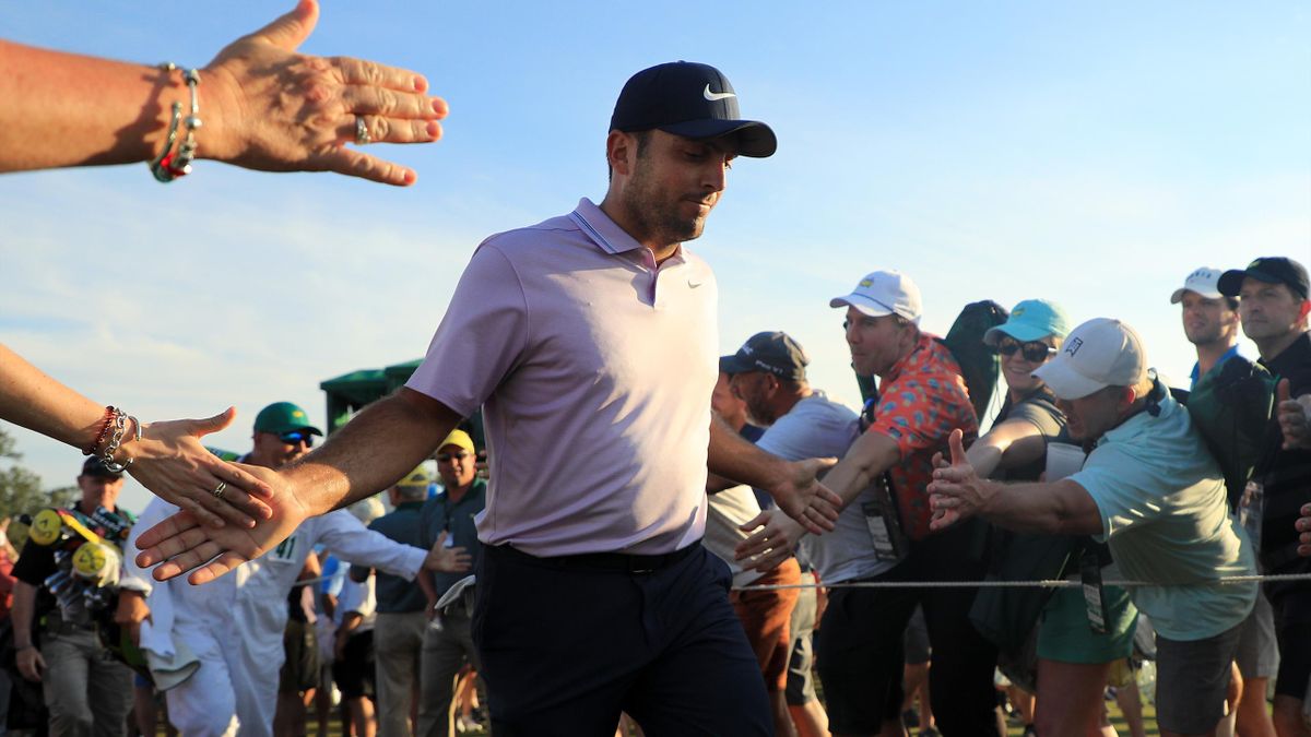 Francesco Molinari of Italy high fives patrons as he walks off the 18th green during the third round of the Masters at Augusta National Golf Club on April 13, 2019 in Augusta