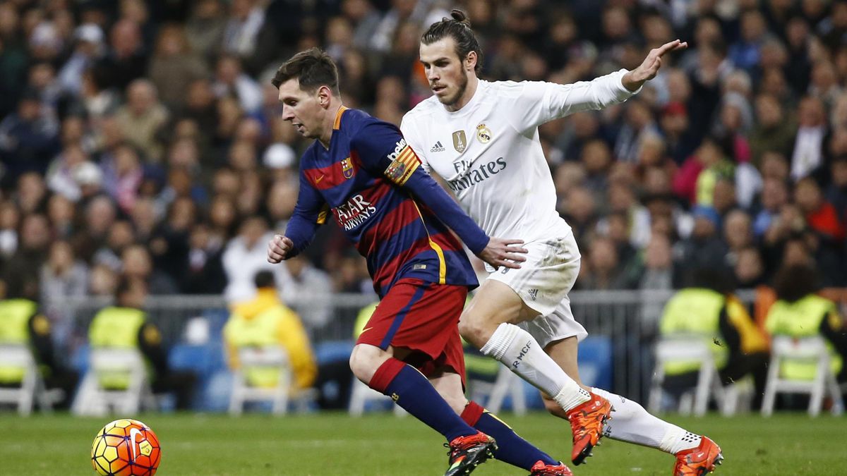 Real Madrid's Gareth Bale in action with Barcelona's Lionel Messi