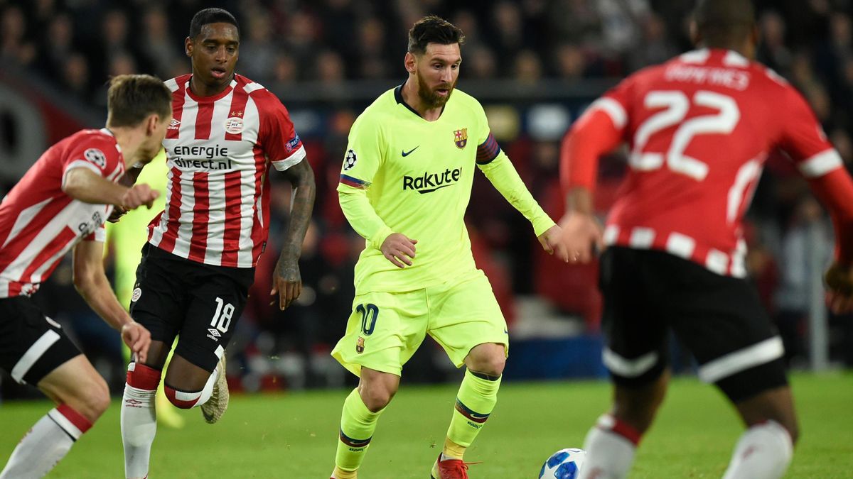 Barcelona's Argentine forward Lionel Messi (C) vies with Eindhoven's players during the UEFA Champions League football match between PSV Eindhoven and FC Barcelona at Philips stadium in Eindhoven on November 28, 2018.