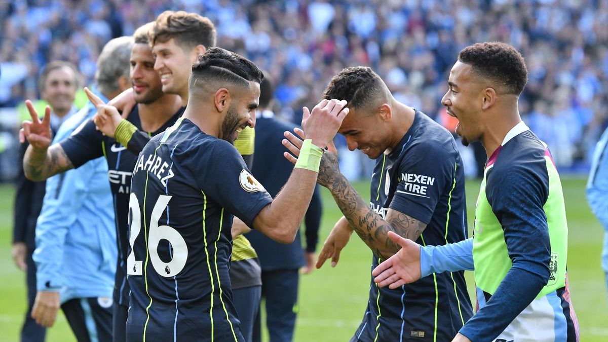 Riyad Mahrez (26) of Manchester City celebrates winning the Premier League title at full time with his team mates after the Premier League match between Brighton & Hove Albion and Manchester City at American Express Community Stadium on May 12, 2019 in Br
