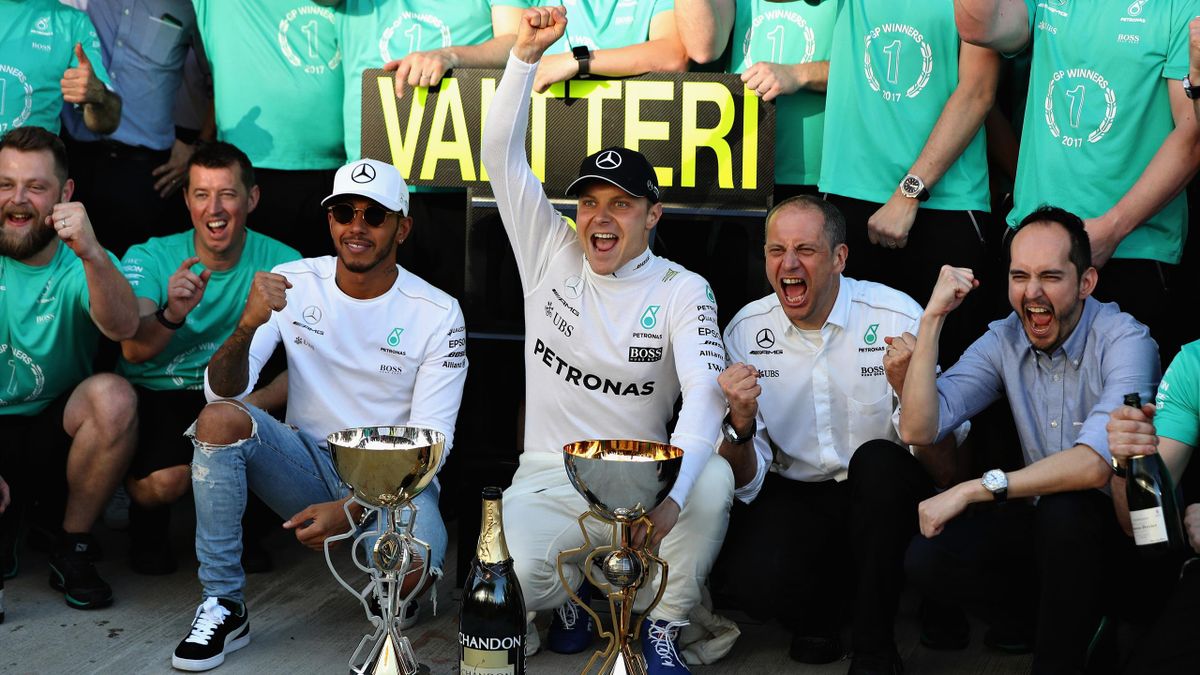 Race winner Valtteri Bottas of Finland and Mercedes GP, celebrates his win with team mate Lewis Hamilton of Great Britain and Mercedes GP and the rest of the Mercedes GP team during the Formula One Grand Prix of Russia on April 30, 2017 in Sochi, Russia