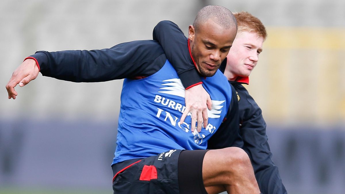 Belgium's national footbal team Vincent Kompany and Kevin De Bruyne fight for the ball during a training session of the Red Devils on March 4