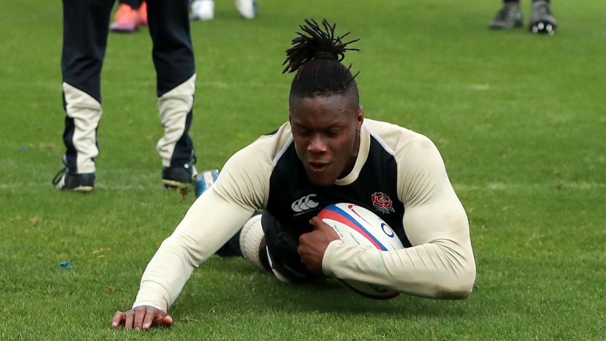 Maro Itoje falls as he goes past England head coach Eddie Jones during the England training session held at Pennyhill Park on March 05, 2019 in Bagshot, England.