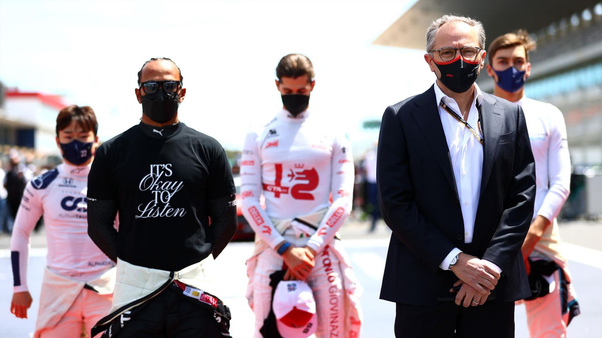 Lewis Hamilton of Great Britain and Mercedes GP and Stefano Domenicali, CEO of the Formula One Group, stand on the grid for the national anthem prior to the F1 Grand Prix of Portugal at Autodromo Internacional Do Algarve on May 02, 2021 in Portimao, Portu