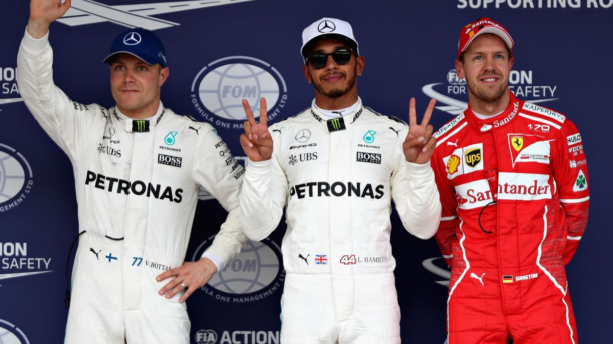 Top three qualifiers Lewis Hamilton of Great Britain and Mercedes GP, Valtteri Bottas of Finland and Mercedes GP and Sebastian Vettel of Germany and Ferrari in parc ferme during qualifying for the Formula One Grand Prix of Japan at Suzuka Circuit.