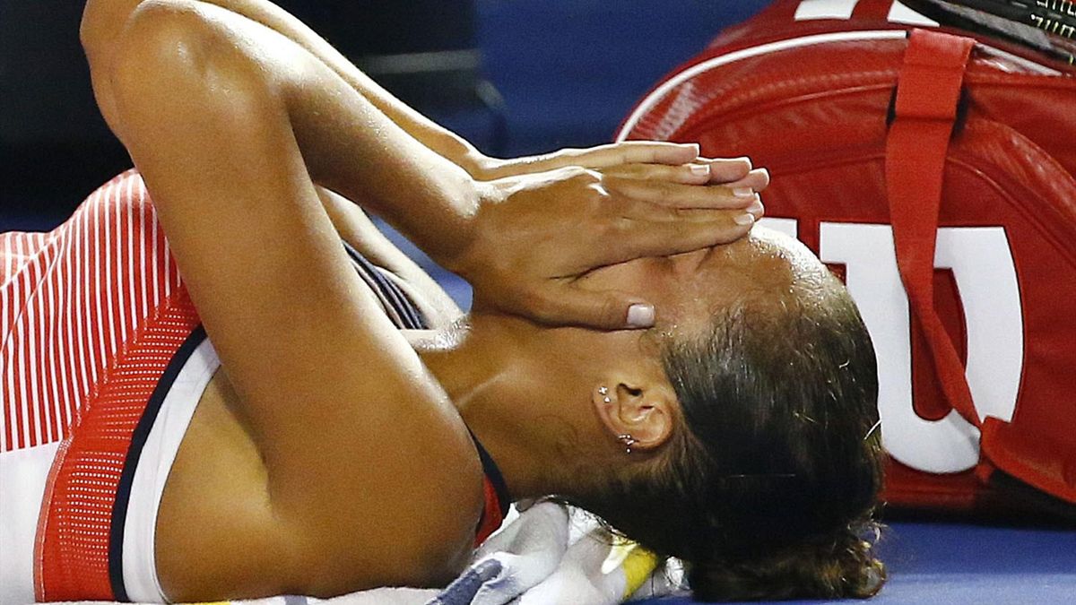 Madison Keys of the U.S. reacts as she receives medical attention during her fourth round match against China's Zhang Shuai at the Australian Open tennis tournament at Melbourne Park, Australia, January 25,