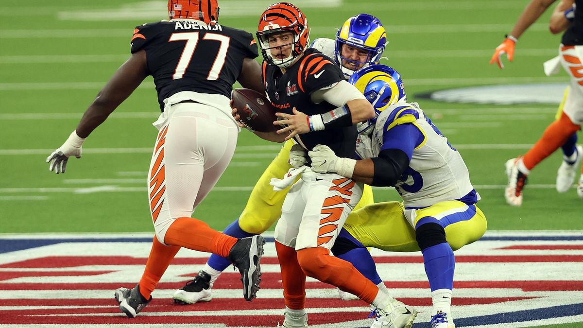 Aaron Donald #99 of the Los Angeles Rams sacks Joe Burrow #9 of the Cincinnati Bengals in the fourth quarter during Super Bowl LVI at SoFi Stadium