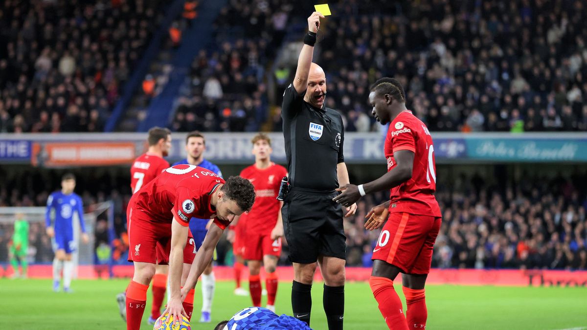 Sadio Mane of Liverpool is shown a yellow card by Match Referee Anthony Taylor for a foul on Cesar Azpilicueta during the Premier League match between Chelsea and Liverpool at Stamford Bridge on January 02, 2022