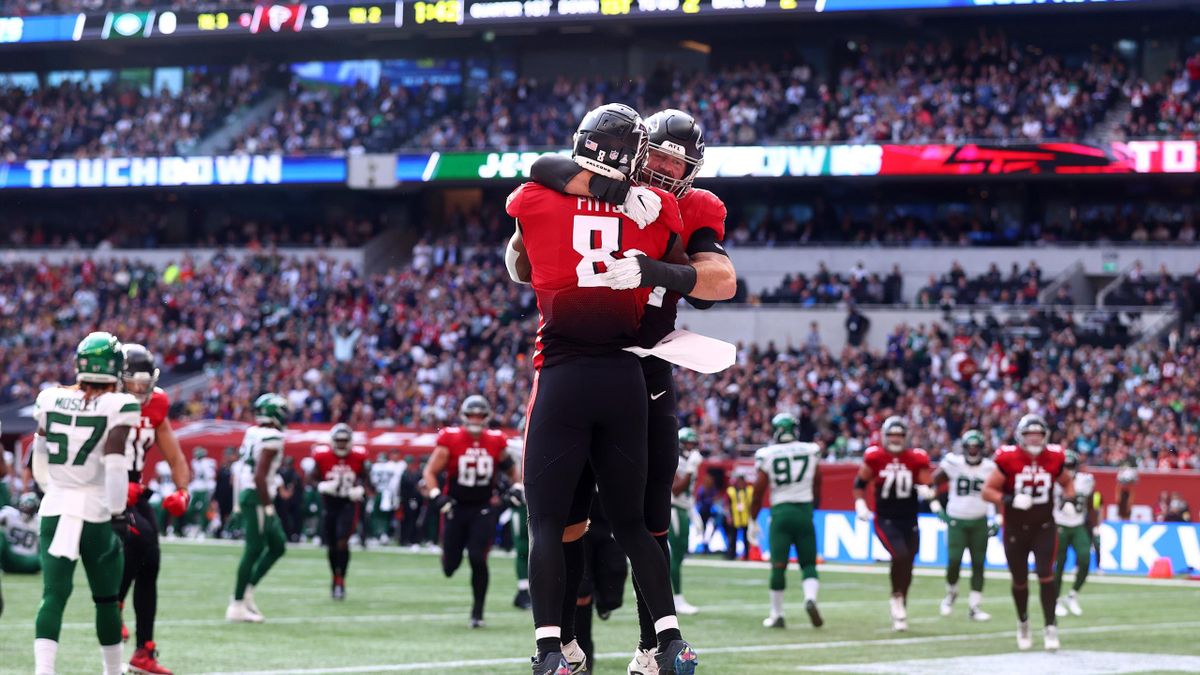 Kyle Pitts #8 of the Atlanta Falcons celebrates after he scores the first touchdown during the NFL London 2021 match between New York Jets and Atlanta Falcons at Tottenham Hotspur Stadium
