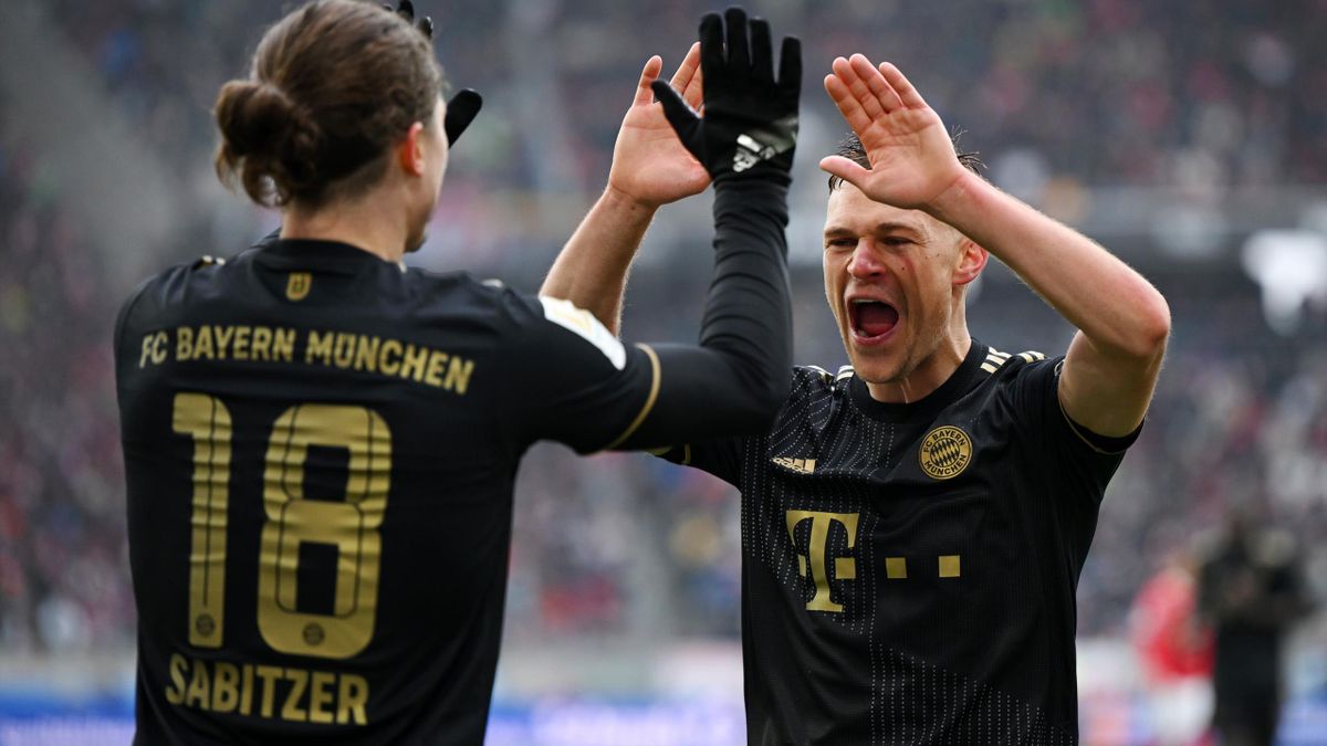 Marcel Sabitzer of FC Bayern Muenchen (L) celebrates with teammate Joshua Kimmich after scoring their team's fourth goal during the Bundesliga match between Sport-Club Freiburg and FC Bayern München at Europa-Park Stadion on April 02, 2022 in Freiburg