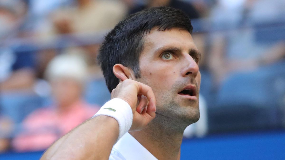 Serbia's Novak Djokovic wants to hear the crowd cheer louder after winning a point against Japan's Kei Nishikori during their 2021 US Open Tennis tournament men's singles third round match at the USTA Billie Jean King National Tennis Center
