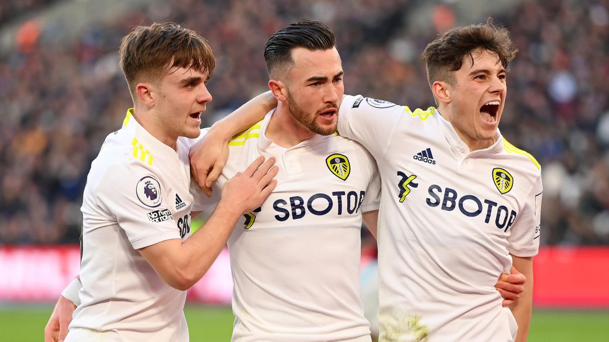 Jack Harrison celebrates with Lewis Bate and Daniel James of Leeds Unitedafter scoring their team's third goal during the Premier League match between West Ham United and Leeds United at London Stadium on January 16, 2022 in London, England.