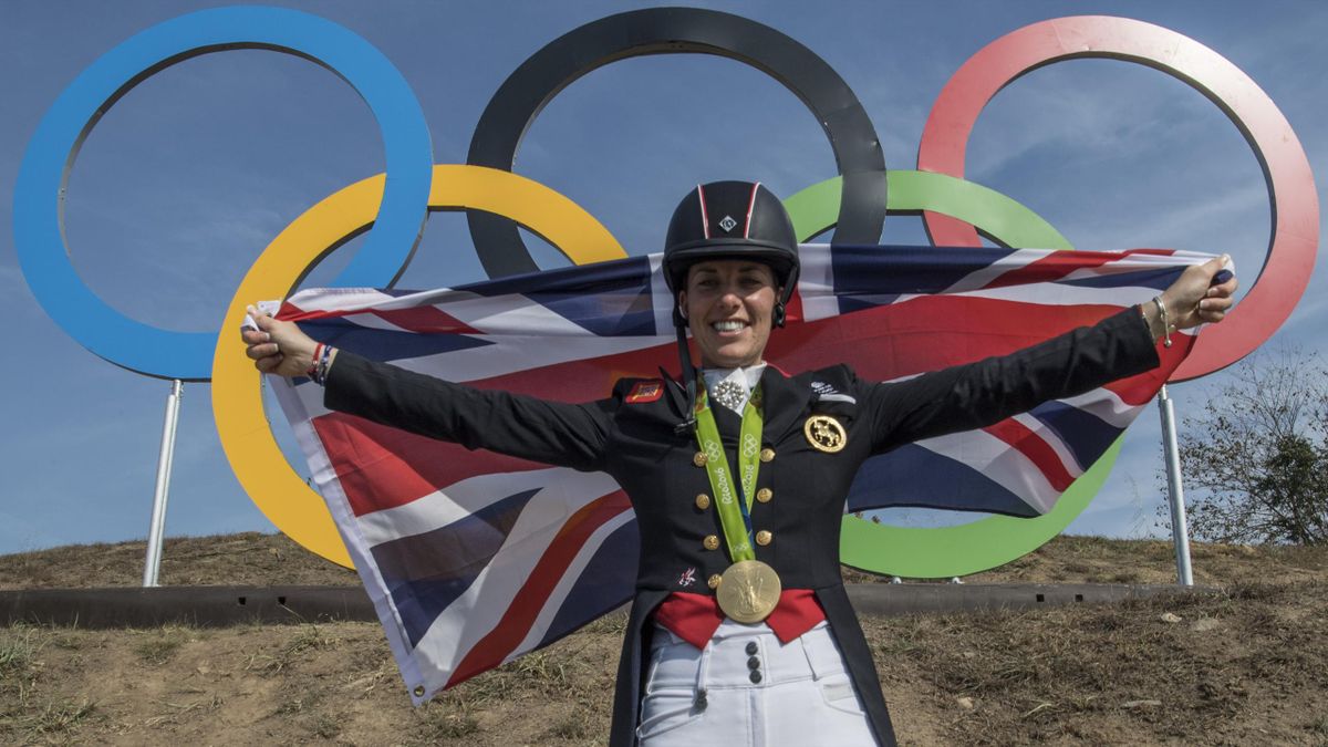 Britain's Charlotte Dujardin poses with her gold medal in front of the Olympic rings after the Equestrian's Dressage Grand Prix Freestyle event of the 2016 Rio Olympic Games at the Olympic Equestrian Centre in Rio de Janeiro, Brazil on August 15, 2016