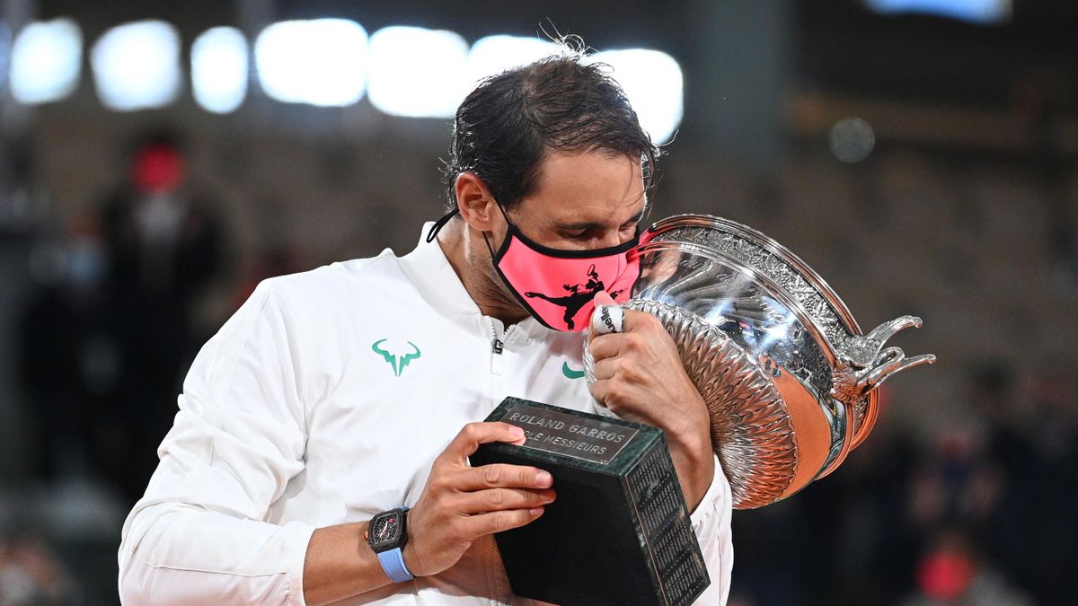 Spain's Rafael Nadal kisses the Mousquetaires Cup (The Musketeers) as he celebrates during the podium ceremony after winning the men's singles final tennis match against Serbia's Novak Djokovic at the Philippe Chatrier court at Roland Garros