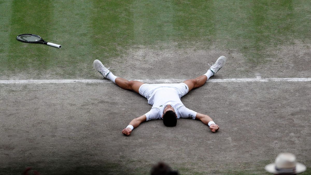 Djokovic collapses to the turf after his record-equalling win