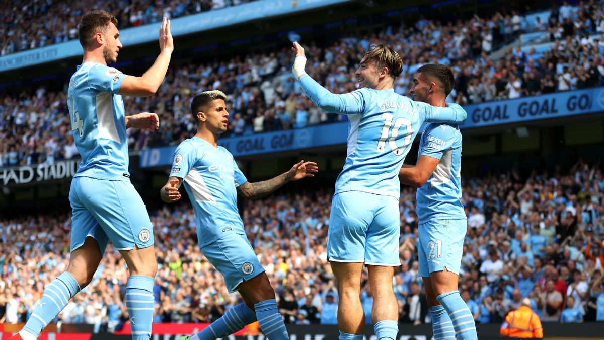 MANCHESTER, ENGLAND - AUGUST 28: Ferran Torres of Manchester City celebrates with teammates Aymeric Laporte, Joao Cancelo, and Jack Grealish after scoring his team's second goal during the Premier League match between Manchester City and Arsenal at Etihad