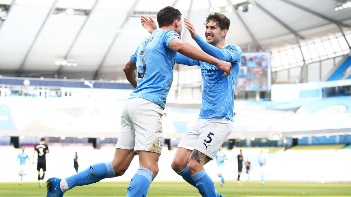 Ruben Dias of Manchester City celebrates with teammate John Stones after scoring
