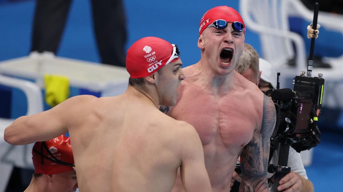 James Guy of Team Great Britain (L) and Adam Peaty of Team Great Britain celebrate winning gold in the Mixed 4 x 100m Medley Relay Final at Tokyo Aquatics Centre on July 31, 2021 in Tokyo, Japan.