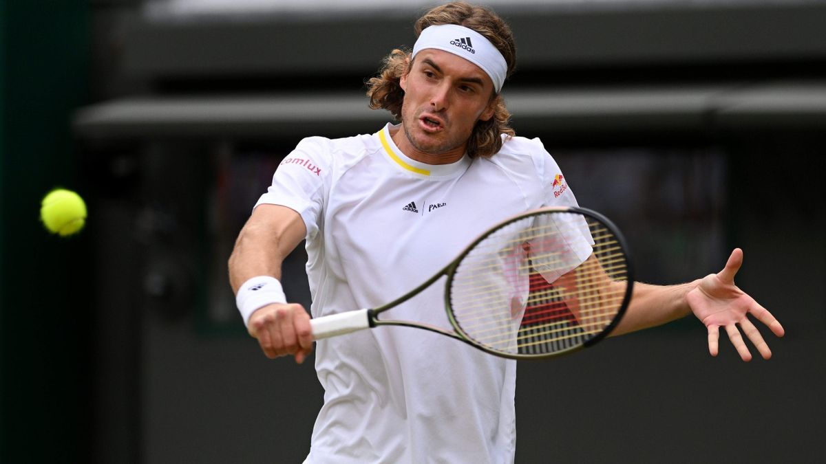 Stefanos Tsitsipas of Greece plays a backhand against Nick Kyrgios of Australia during their Men's Singles Third Round match on day six of The Championships Wimbledon 2022 at All England Lawn Tennis and Croquet Club on July 02, 2022 in London