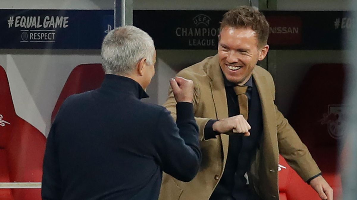 Jose Mourinho (L) and Leipzig's German headcoach Julian Nagelsmann do the "elbow bump" as they greet each other