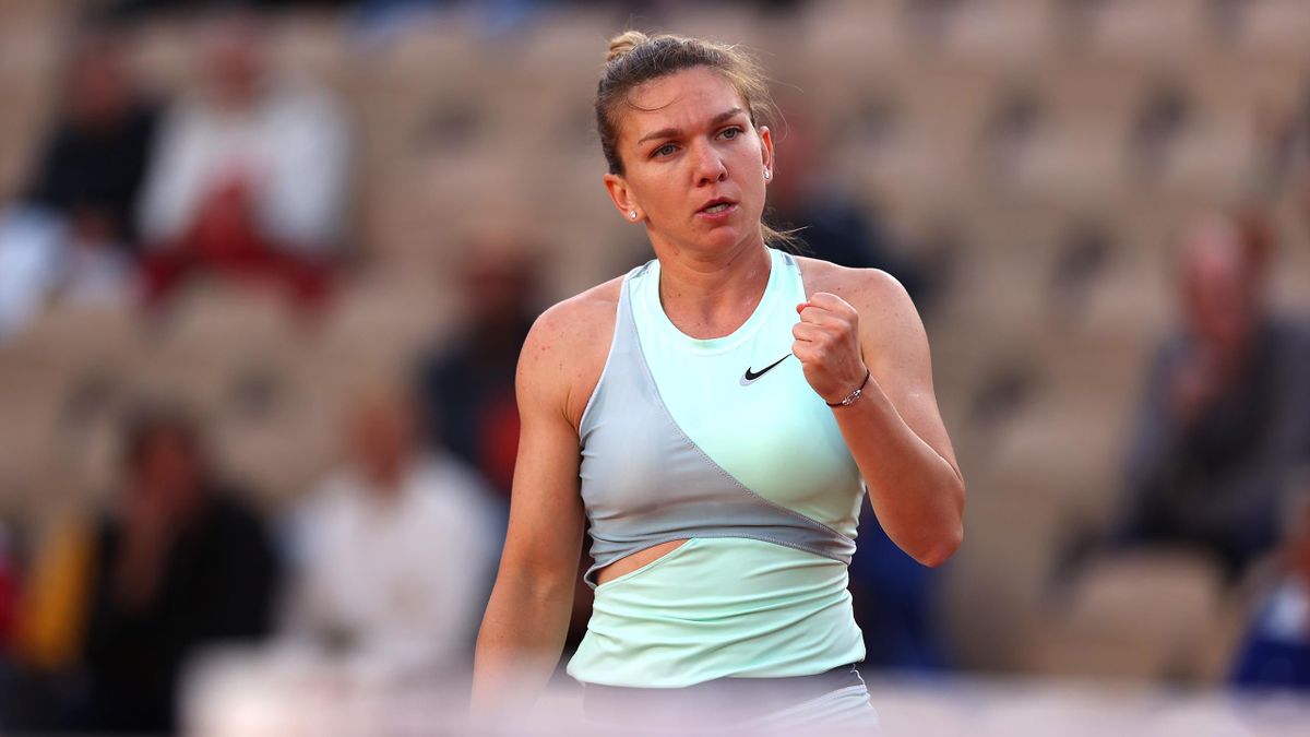 Simona Halep of Romania reacts against Nastasja Schunk of Germany during the Women's Singles First Round match on Day 3 of the French Open