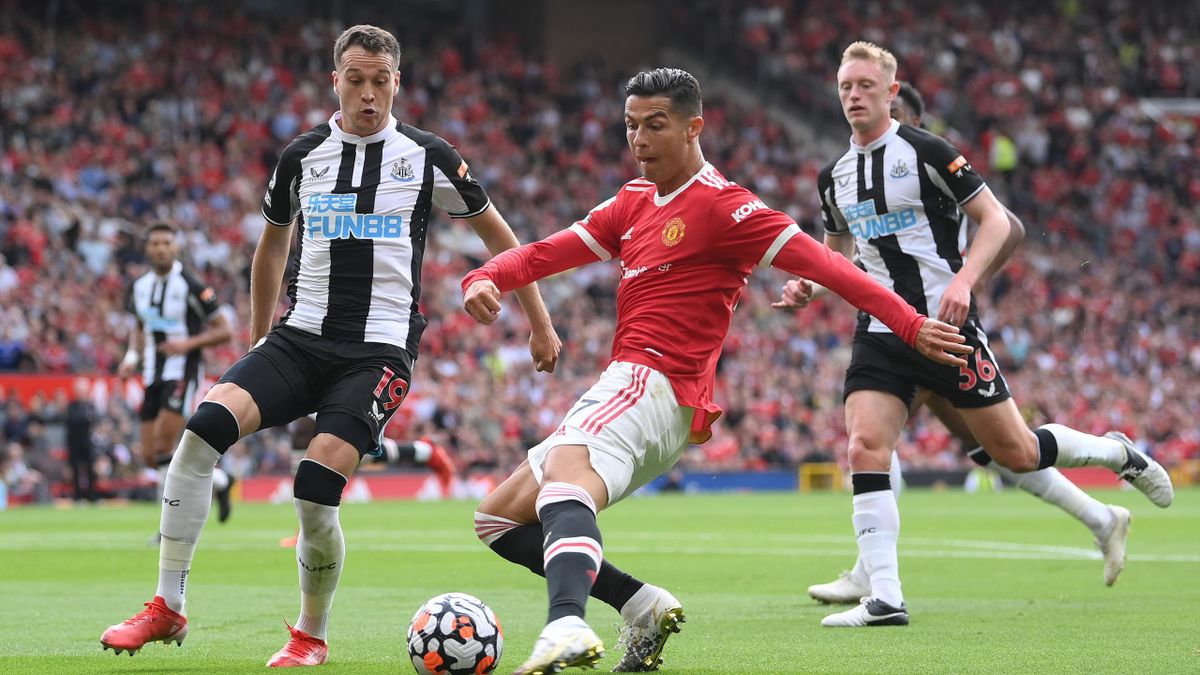 Cristiano Ronaldo of Manchester United shoots whilst under pressure from Javier Manquillo of Newcastle United during the Premier League match between Manchester United and Newcastle United at Old Trafford on September 11, 2021 in Manchester, England