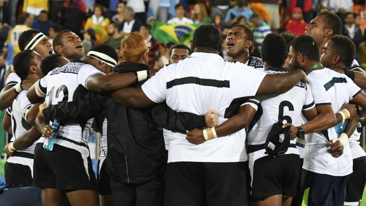 Fiji's players pray after victory in the men’s rugby sevens gold medal match between Fiji and Britain during the Rio 2016 Olympic Games at Deodoro Stadium in Rio de Janeiro on August 11, 2016