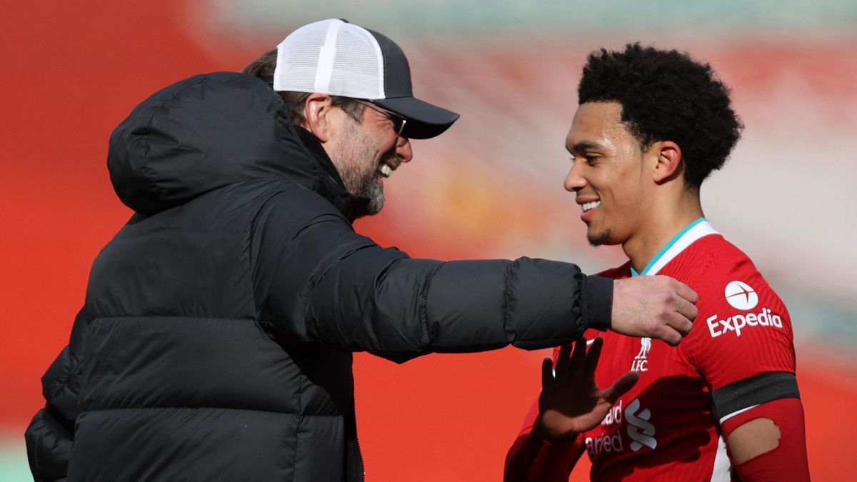 Liverpool's German manager Jurgen Klopp (L) congratulates Liverpool's English defender Trent Alexander-Arnold after the English Premier League football match between Liverpool and Aston Villa at Anfield in Liverpool, north west England on April 10, 2021.