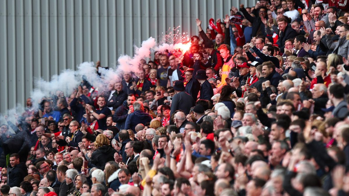 Liverpool fans let of flare at full time during the Premier League match between Liverpool and Middlesbrough at Anfield on May 21, 2017 in Liverpool, England.