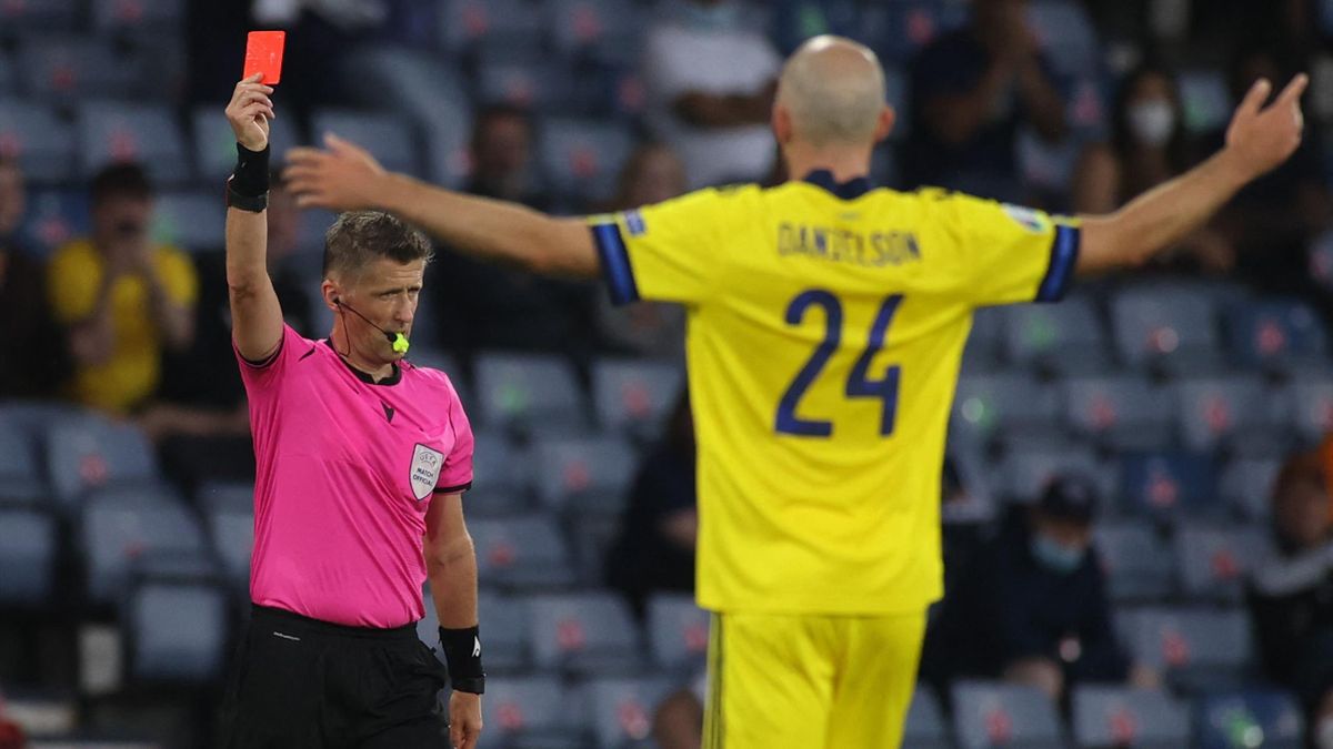 Daniele Orsato (L) shows a red card to Sweden's defender Marcus Danielsson
