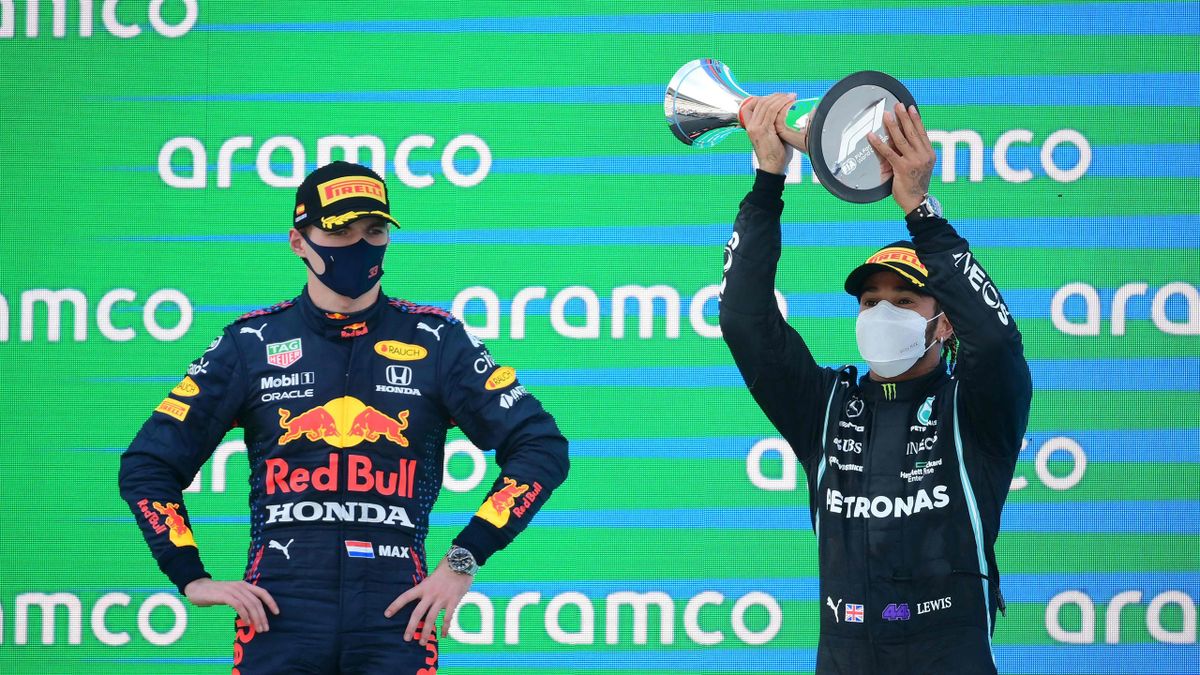 Mercedes' British driver Lewis Hamilton (R) celebrates on the podium next to Red Bull's Dutch driver Max Verstappen after the Spanish Formula One Grand Prix race at the Circuit de Catalunya on May 9, 2021 in Montmelo on the outskirts of Barcelona