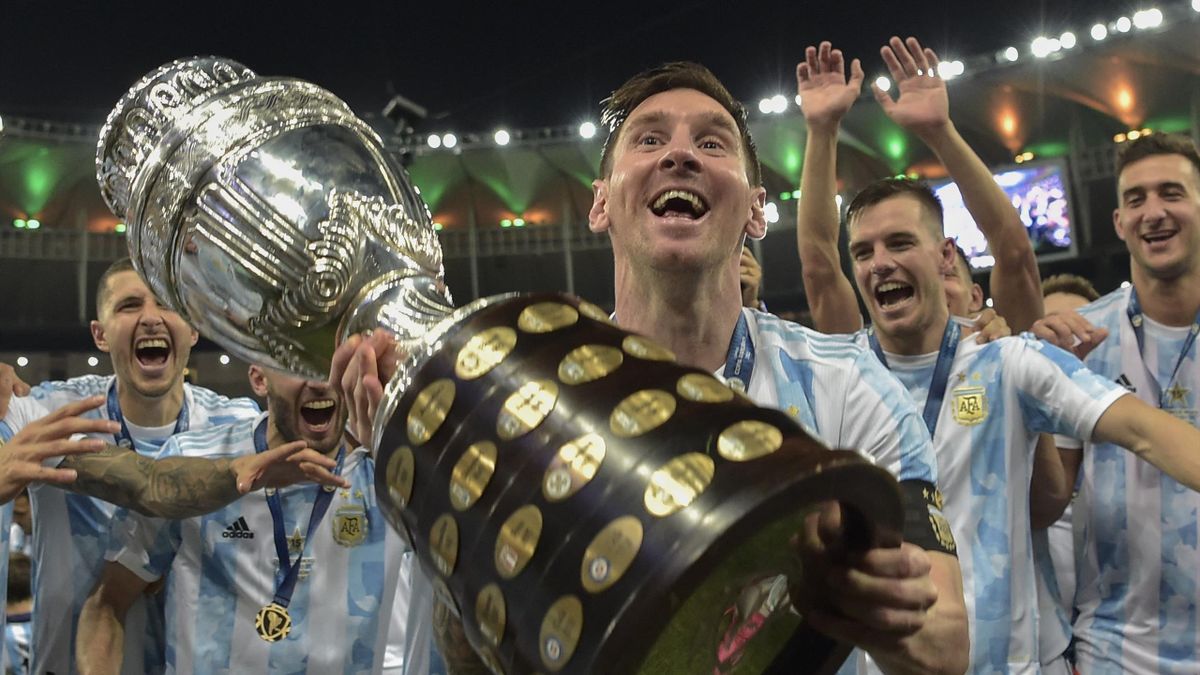 Argentina's Lionel Messi holds the trophy as he celebrates with teammates after winning the Conmebol 2021 Copa America football tournament final match against Brazil at Maracana Stadium in Rio de Janeiro, Brazil, on July 10, 2021. - Argentina won 1-0