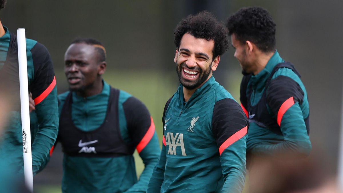 Mohamed Salah of Liverpool laughs during a training session